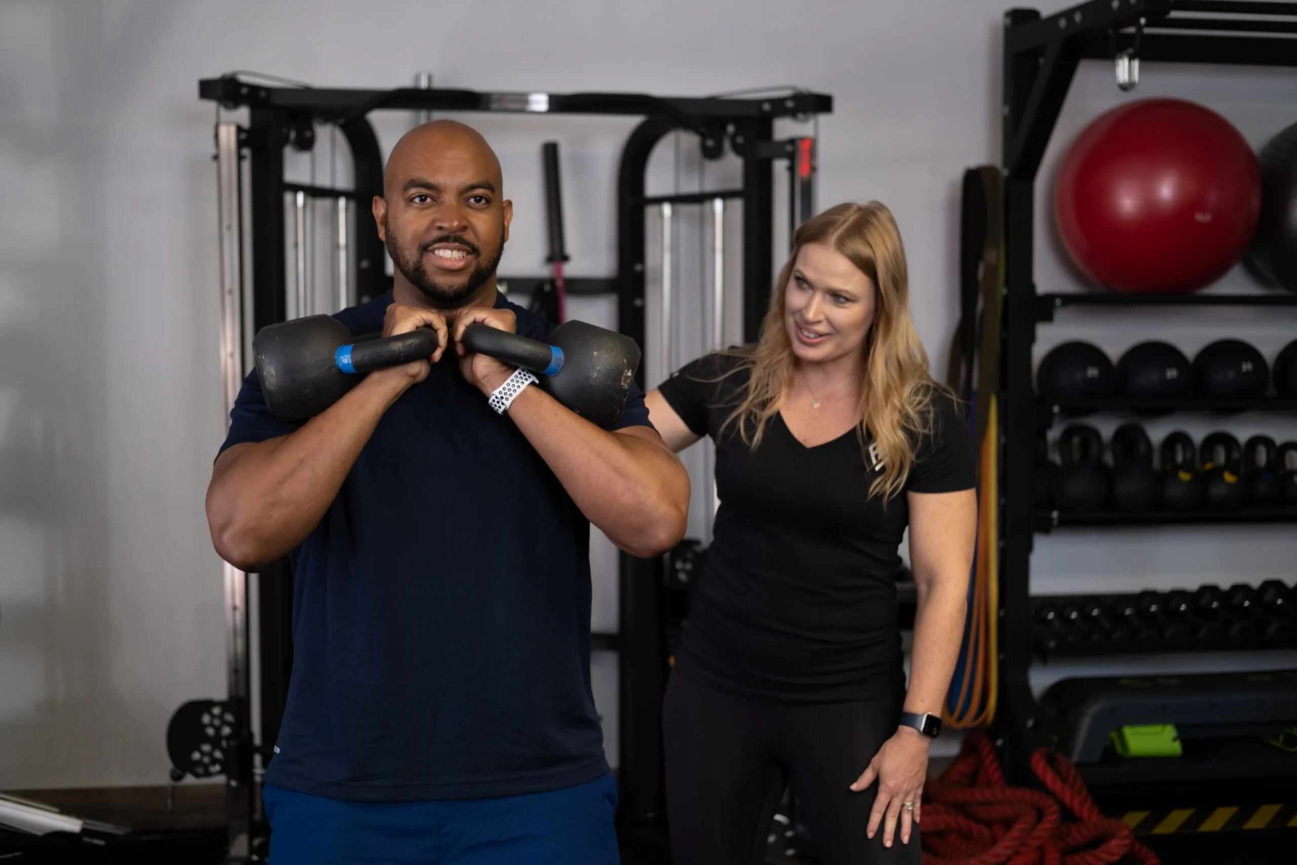 Personal trainers smiling in gym
